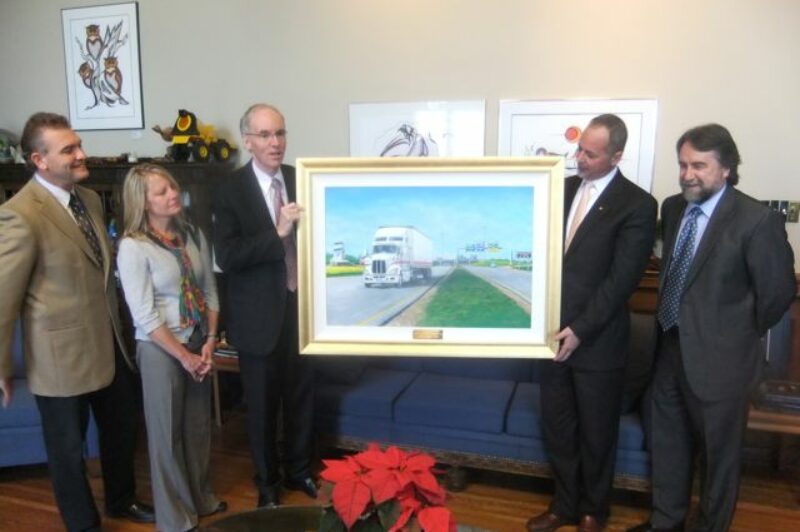 The MTA recently gave this painting to Transport Minister Steve Ashton. Pictured are (l-r): Greg Arndt, Jade Trucking; Susan Snyder, Searcy Trucking; Minister of Infrastructure and Transportation Steve Ashton; MTA president Tom Payne Jr., Payne Transportation; and artist Glenn Hayes.