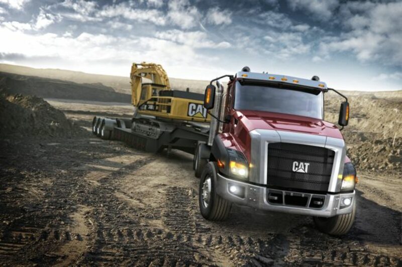 The new Cat CT660 pulls a piece of Caterpillar construction equipment.