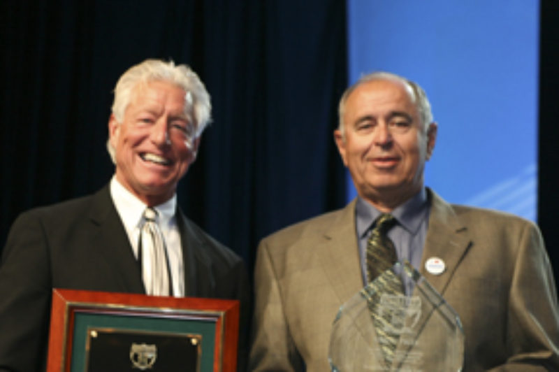 Patrick Kuehl (left), executive vice-president of Great West Casualty Company, presents Brian Kurtz, president of Brian Kurtz Trucking, with the National Fleet Safety Awards grand prize for truckload carrier companies in the small carrier division.