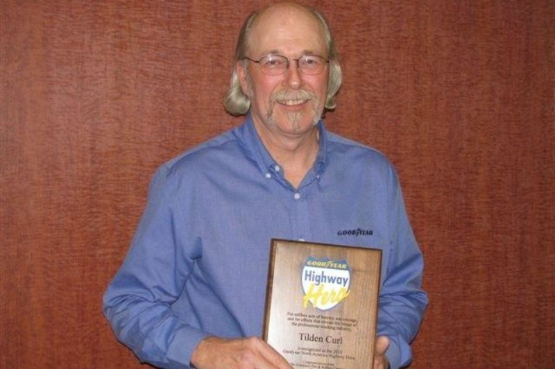 Tilden Curl, an Olympia, Wash.-based truck driver, poses after being named the 2010 winner of Goodyear's North American Highway Hero award at the Mid-America Trucking Show in Louisville, Ky.
