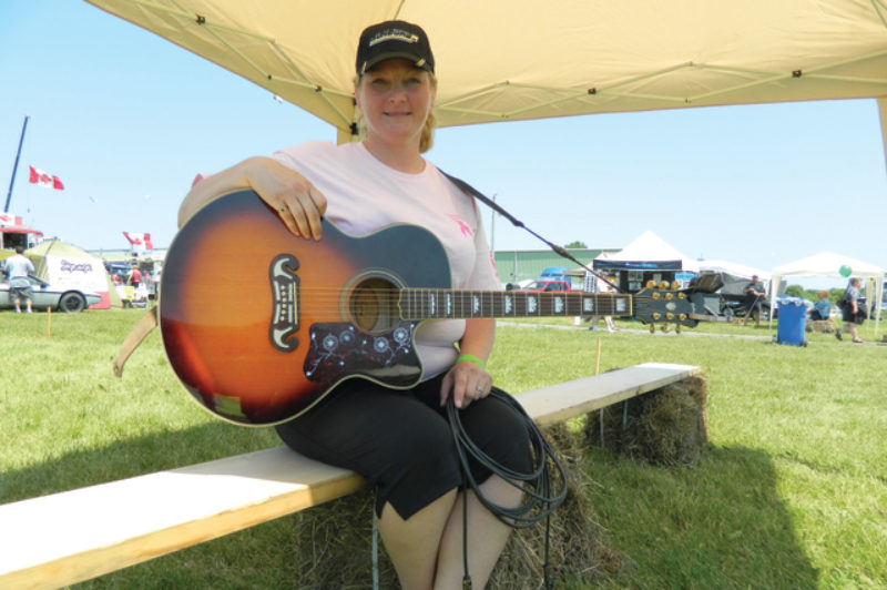 SINGING FOR A CURE: Anne Finley performed her new song Convoy for a Cure at the Stirling Truck Show in mid-June. She plans to donate proceeds from the song to the Canadian Breast Cancer Foundation.  Photo by James Menzies
