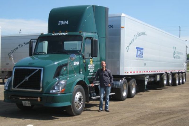 Scott Verspeeten pictured with one of the fleet's new lightweight aluminum trash trailers designed by Titan Trailer.