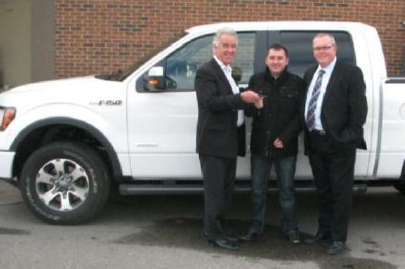 Yanke driver Sasa Gavranovic (centre) is presented with the keys to his new Ford F-150 by Yanke president and CEO Russel Marcoux (left), and company v.p. Craig Bailey. Gavranovic won the truck as part of Yanke's 