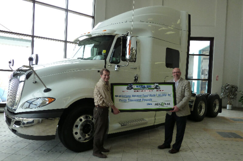 Harry Dornn (right), marketing director with Maxim Truck and Trailer, presents David Northcott, executive director of the Winnipeg Harvest food bank, with a cheque good for 30,000 lbs of food on March 19. Maxim made the donation following a company-wide weight-loss challenge, making a donation for each pound lost by participants.