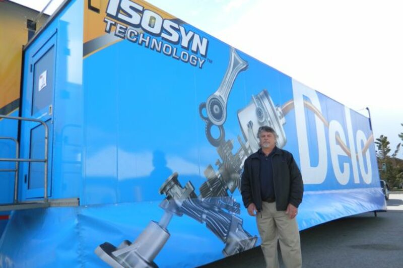 Larry Harris, president of RP Oil, stands beside the Delo Truck during its appearance at his location in Whitby, Ont.