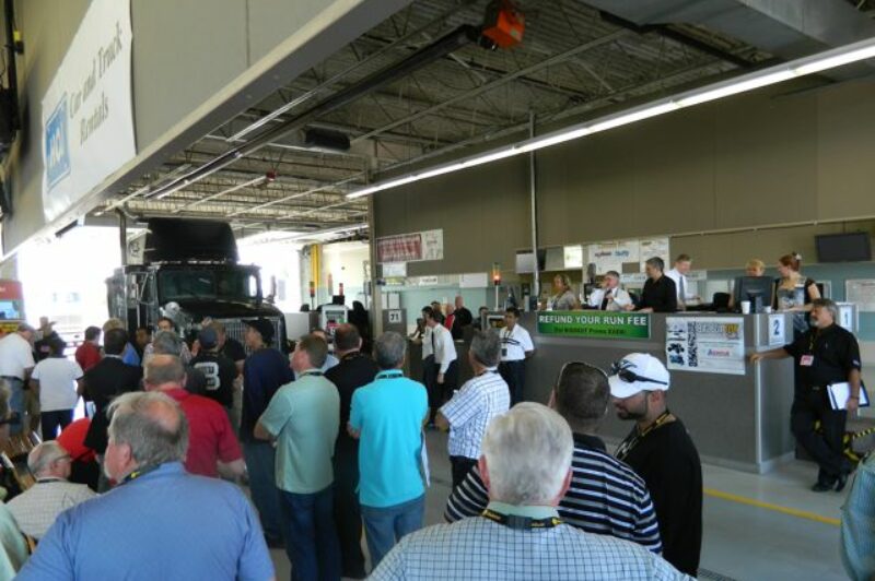 Potential buyers gather around to bid on an International tractor.