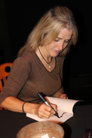 Author Annie Wilder signs a copy of her new book Trucker Ghost Stories.