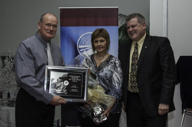 2012 Driver of the Year winner Ed Dueck of Big Freight Systems (left), poses with wife, Marcie,and Randy Fleming of Volvo Trucks Canada.