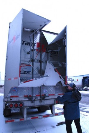 Trans-West fleet director Michel Morin opens a fuel-saving TrailerTail from ATDynamics. (Photo by Carroll McCormick)
