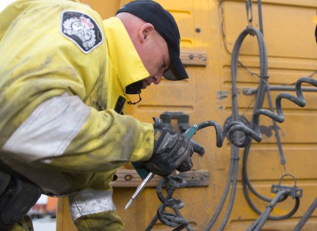 Const. Ken Usipiuk inspects a truck at Harbour Link Container Services' facility in Delta, B.C. Photo by The Delta Optimist.