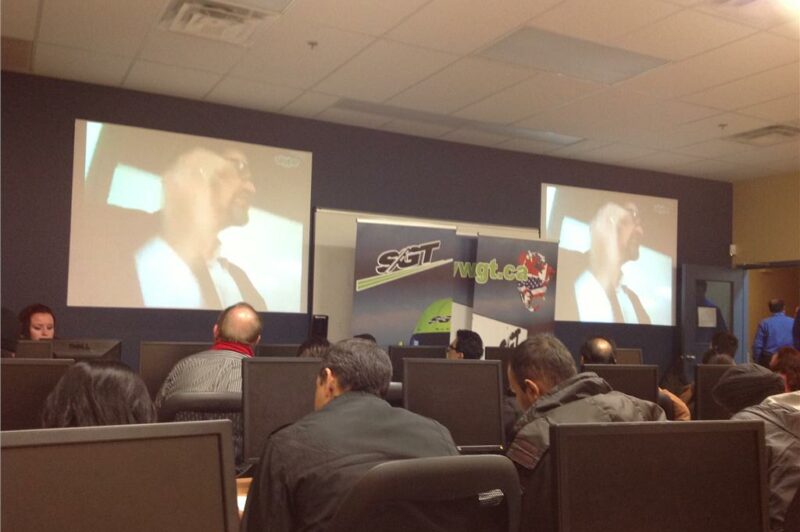 triOS College chairman and CEO Frank Gerencser speaks with potential students at the Trucking Career Expo, held at the school's Brampton campus Feb. 12. The event was so well attended, an overflow room was set up to accommodate the extra numbers.