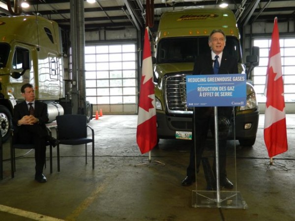 CTA's David Bradley looks on as Environment Minister Peter Kent announces Canada will follow the US lead when it comes to adopting GHG standards for heavy trucks.