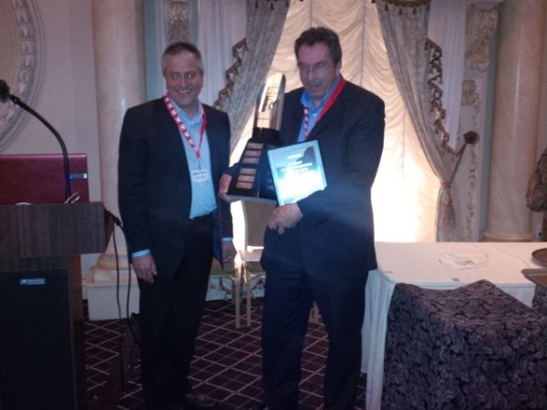 Volvo's Steve de Sousa (left) presents the Canadian Fleet Maintenance Manager of the Year award to John Haines, national fleet director for Canada Cartage.
