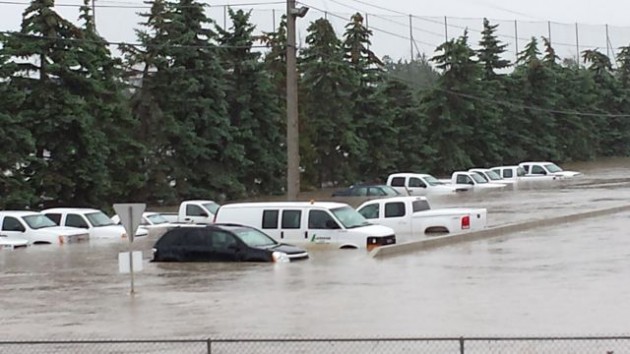 Flooding partially submerged vehicles at Lafarge in Calgary.