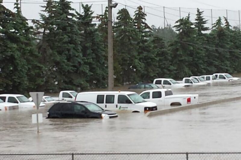 Flooding partially submerged vehicles at Lafarge in Calgary.