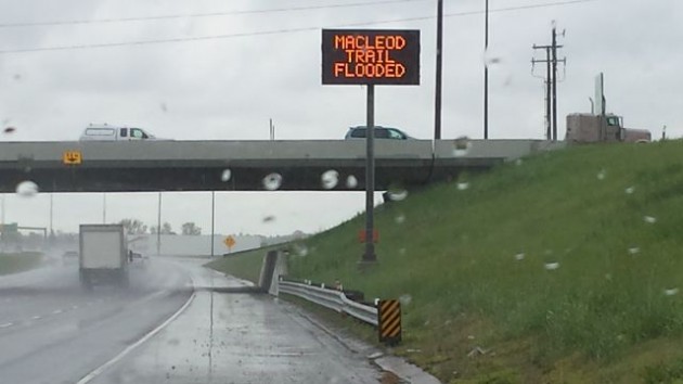 A sign warns that MacLeod Trail is flooded.