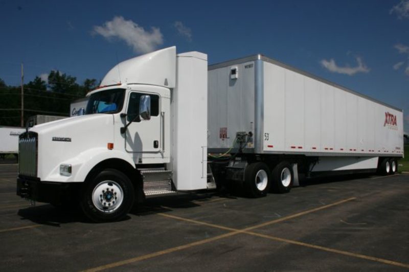 Cabinet-like compressed gas storage mounts to back of cab and saves long tank problem of long tanks on short rails of day-cab tractors.