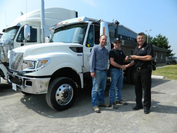 Tallman Truck Centre's Harvey Butcher (right) hands the keys to the company's first TerraStar 4x4 to Schindler Elevator driver Adam Maisonneuve, while Schindler's field supervisor Jeff Couch looks on.