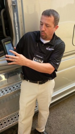 A Detroit Connect official demonstrates how the company's new tablet can be used to ensure better pre-trip inspections.