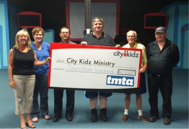 Steve Granville, Fred Pedler, Bob Dawson and Paul Crossman present a big $,1700 cheque to the funding team from City Kidz.