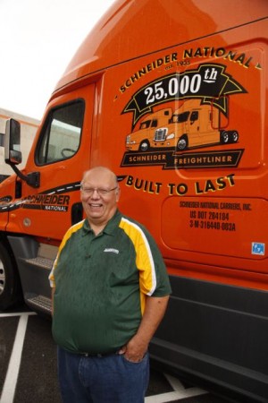 Driver Mike Darras is pictured with his new ride, the 25,000th Freightliner Schneider National has received.