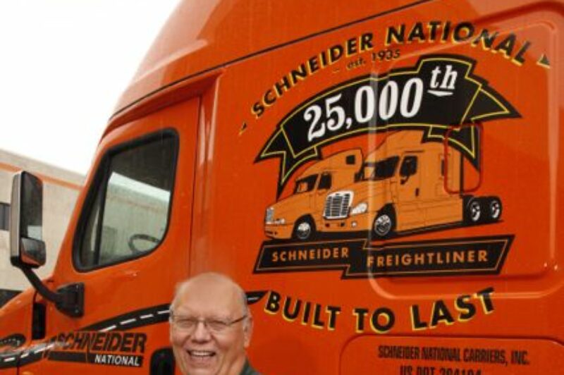 Driver Mike Darras is pictured with his new ride, the 25,000th Freightliner Schneider National has received.