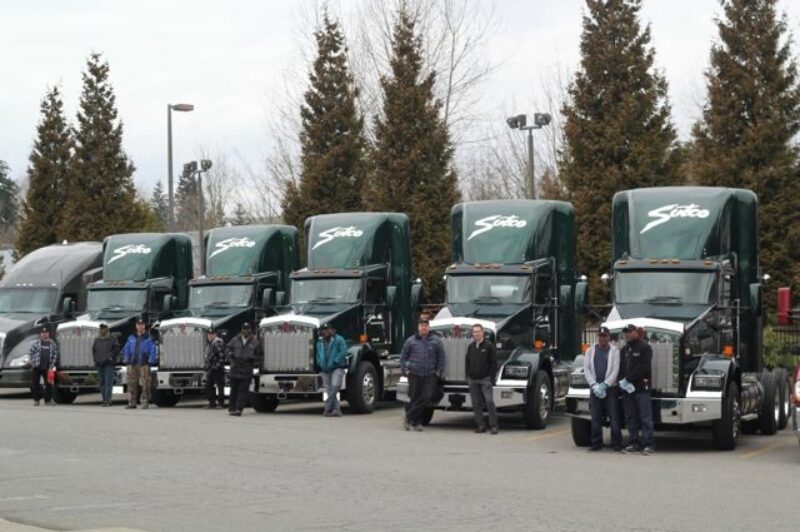 Sutco drivers show off their new LNG-powered Kenworth trucks.