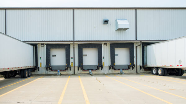 Warehouse building with 53 foot dry van trailers backed into docking doors alternate text for this image