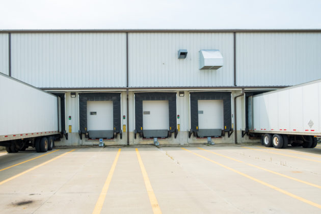 Warehouse building with 53 foot dry van trailers backed into docking doors alternate text for this image