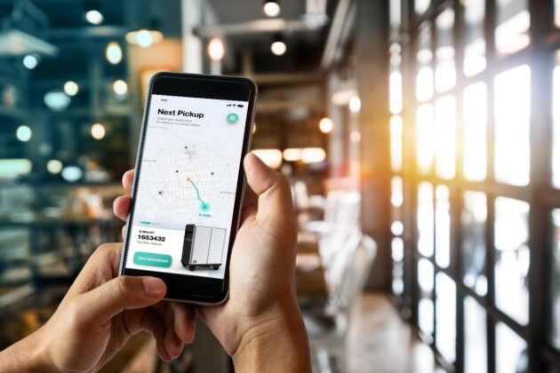 A  man hand holding smart phone device in the coffee shop or caf alternate text for this image