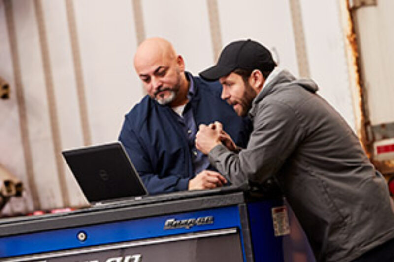 mechanics reviewing shop software