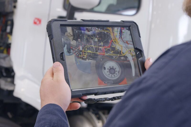 Showing Peterbilt AR technology on tablet