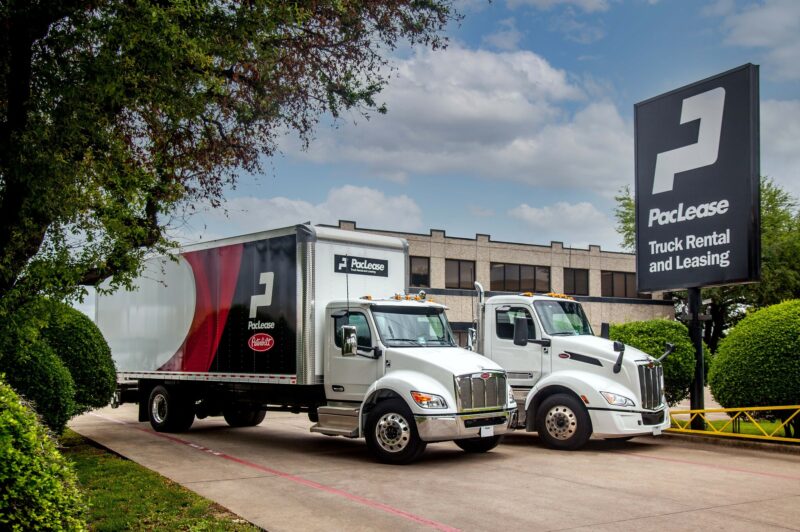 PacLease trucks parked in front of sign