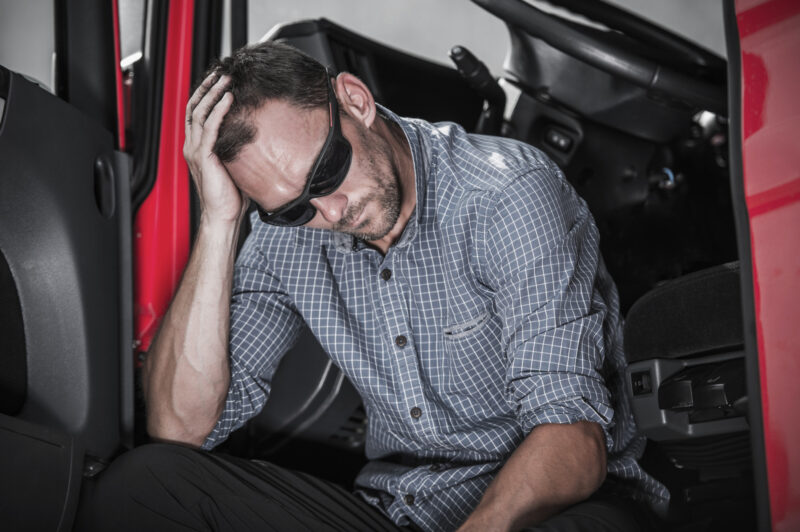 Frustrated Caucasian Semi Truck Driver Having Problem with His Truck and Job.