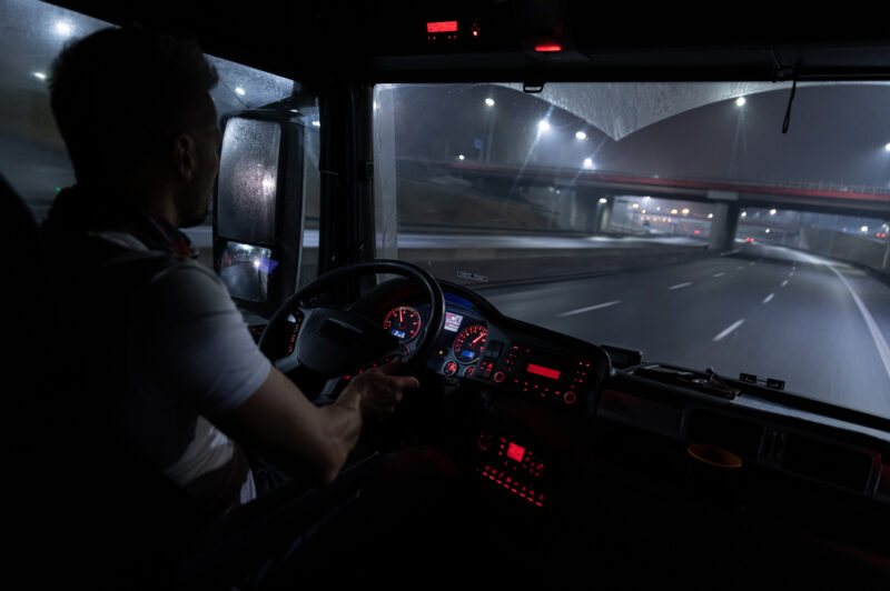 Driver behind the wheel at night