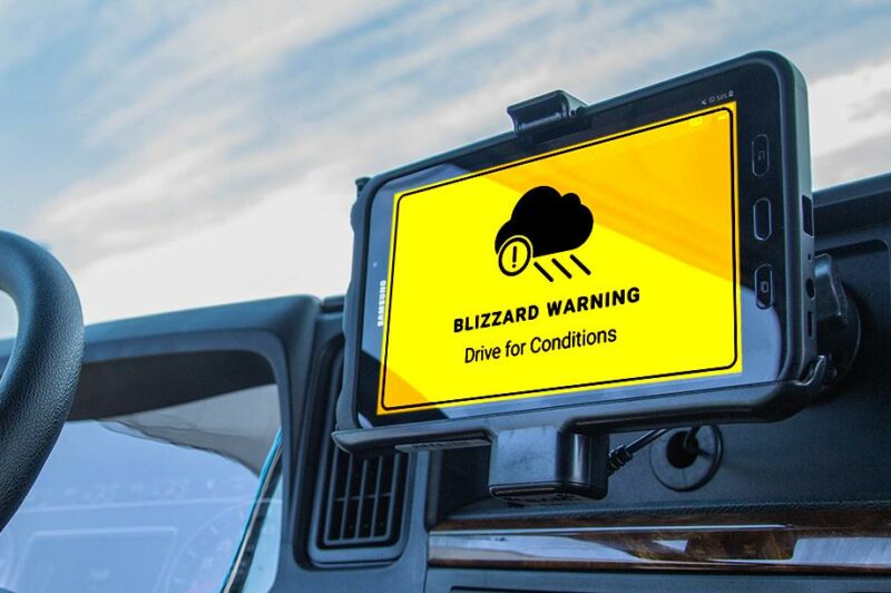 Picture of a severe weather warning issued on a device mounted on a truck's dashboard.