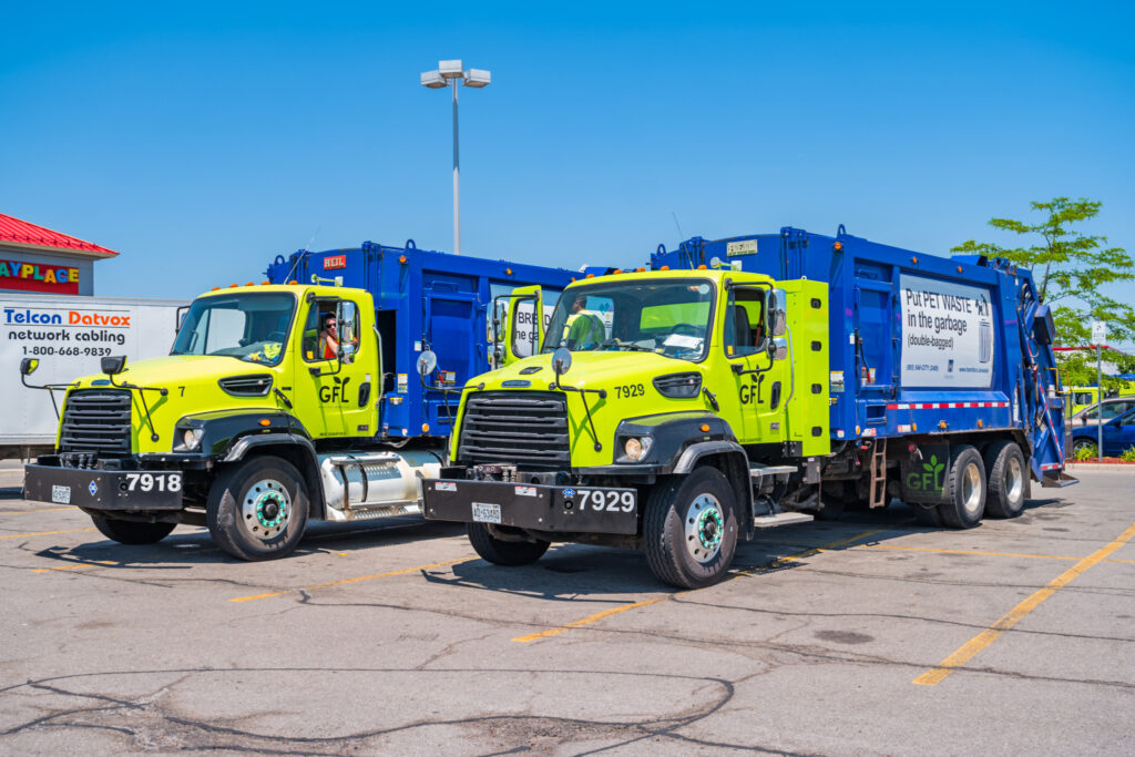 Garbage trucks in a parking lot