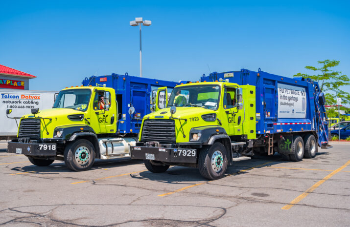 Garbage trucks in a parking lot