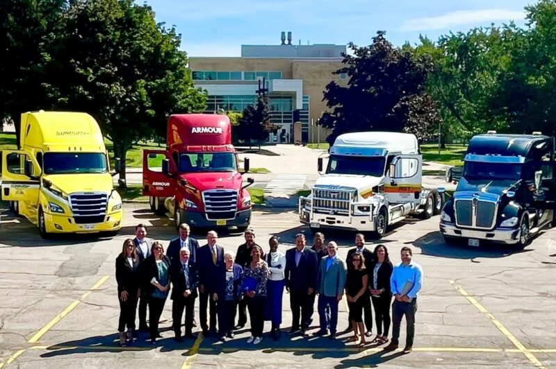 Picture of people standing in front of trucks