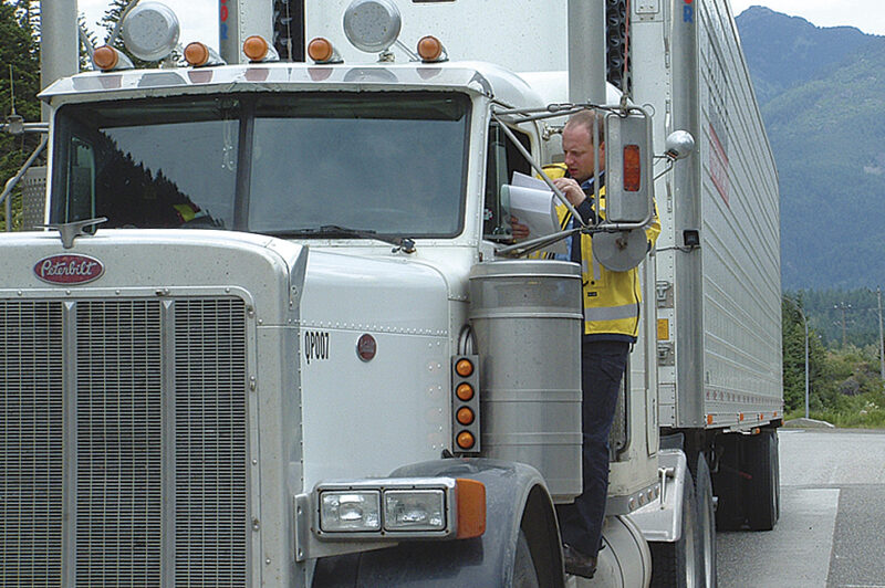Picture of a man on the steps of a truck