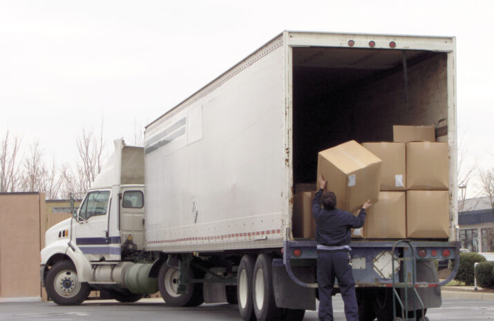 Man unloads boxes from truck