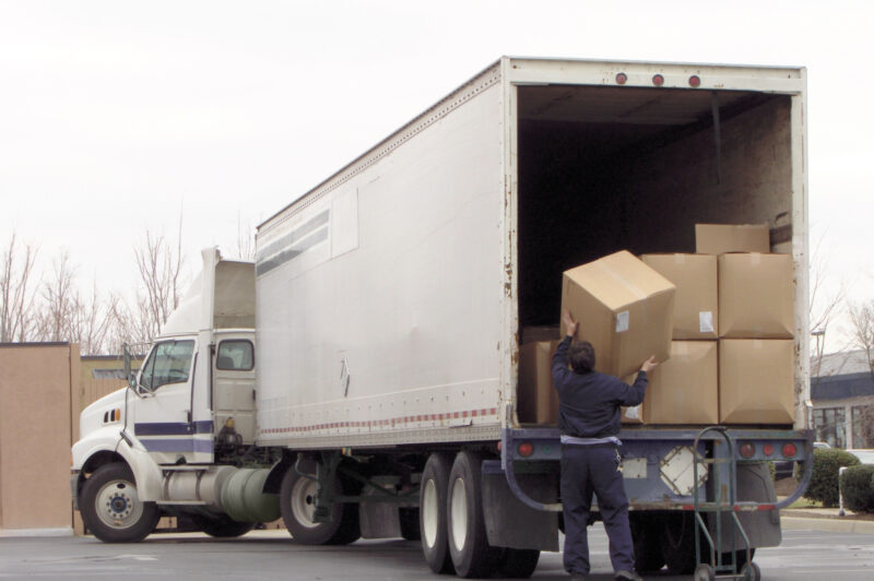 Man unloads boxes from truck