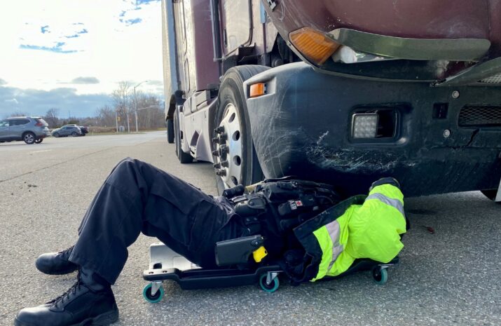 Police officer inspecting a truck