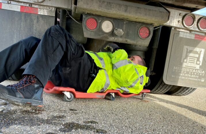 Police officer inspecting a truck