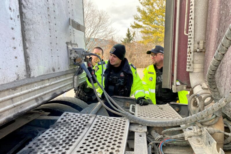 Police officers inspecting a truck