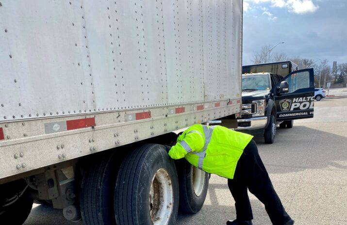 Police officer inspecting a truck