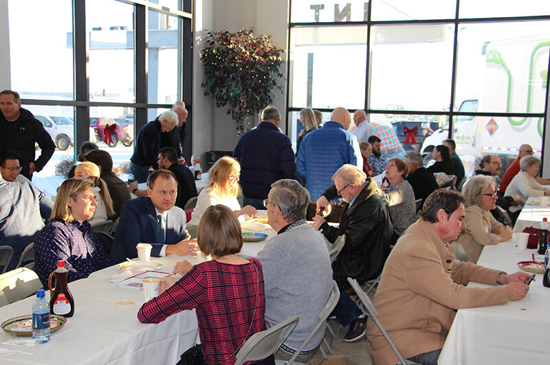 People seated at tables eating breakfast