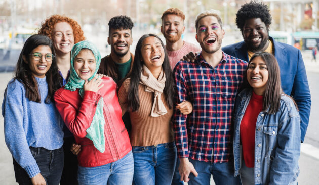 Young diverse people having fun outdoor laughing together – Diversity concept – Main focus on gay man face alternate text for this image