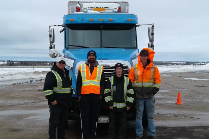 People standing in front of a truck