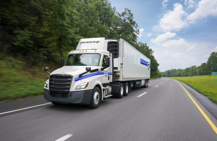 Picture of a Penske truck on a road.